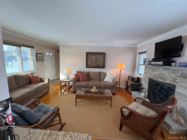 a living room with furniture flat screen tv and a fireplace