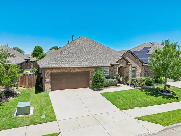 a front view of house with yard garage and green space