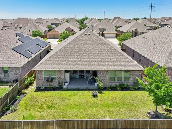 an aerial view of a house with swimming pool patio and balcony