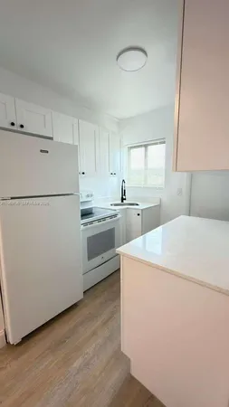 a utility room with cabinets washer and dryer