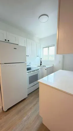 a white refrigerator freezer sitting inside of a kitchen