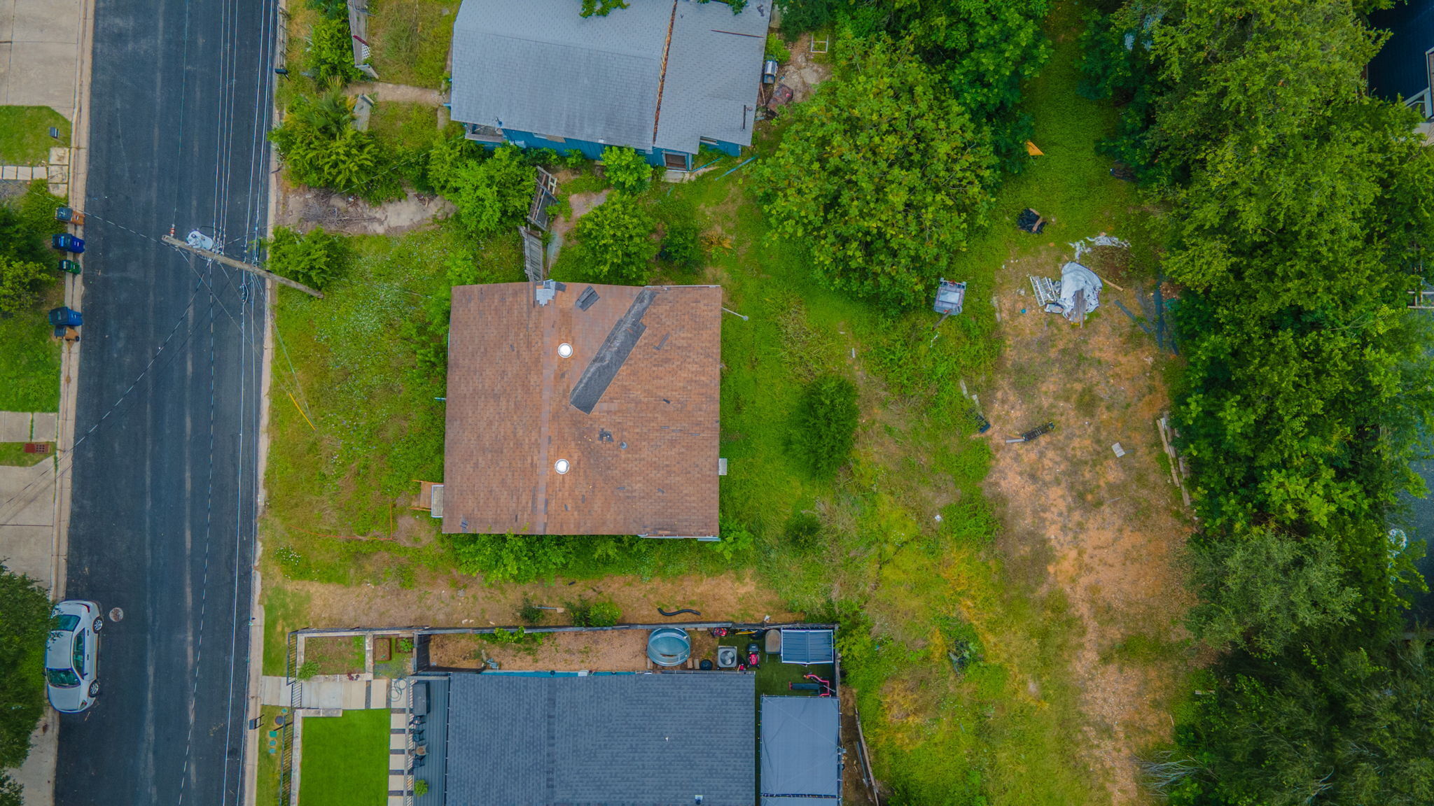 1410 Luna Street Austin, TX 78721 - Photo 2 of 5 An aerial perspective reveals a quiet residential street with ample green space.