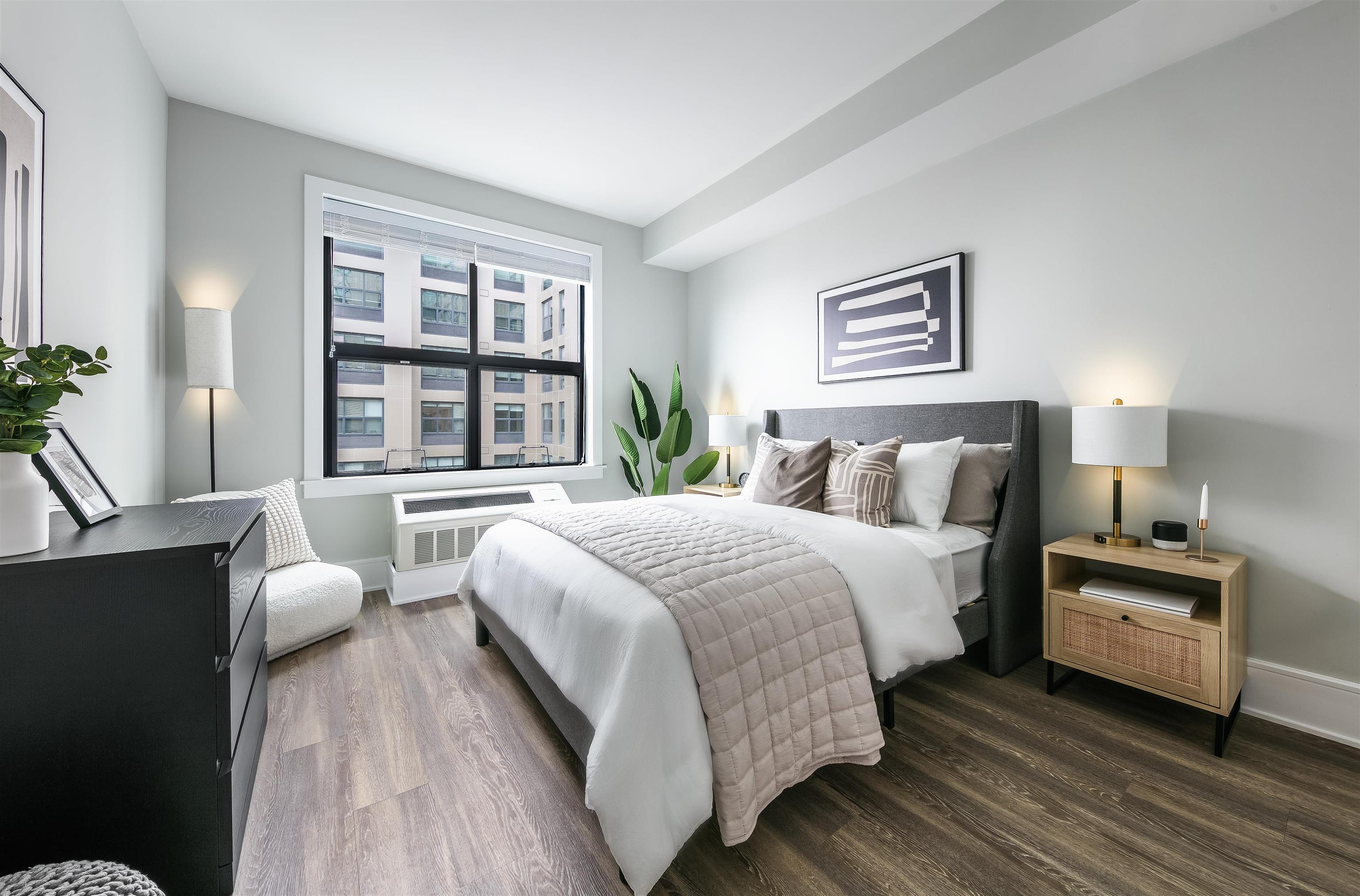 32 Oakland Avenue, Unit 1504 Jersey City, NJ 07306 - Photo 1 of 50 a bedroom with a bed and a large window