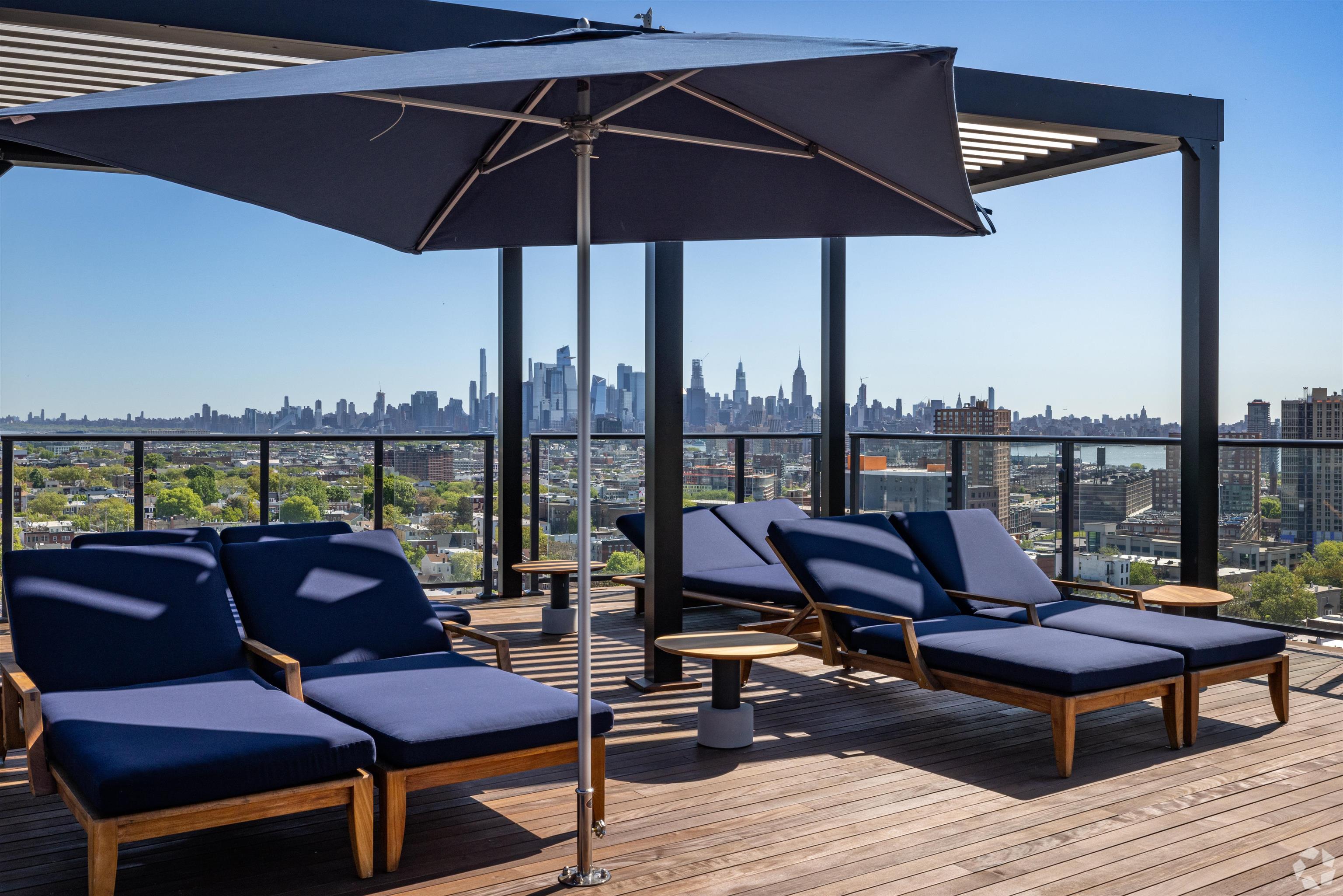 32 Oakland Avenue, Unit 1504 Jersey City, NJ 07306 - Photo 12 of 50 a roof deck with outdoor seating and city view