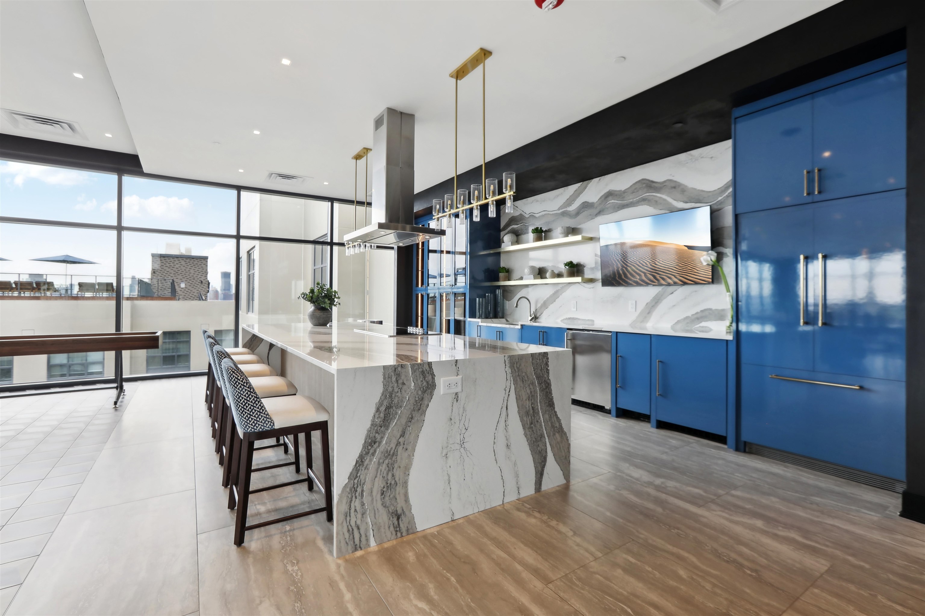 32 Oakland Avenue, Unit 1504 Jersey City, NJ 07306 - Photo 30 of 50 a open kitchen with stainless steel appliances kitchen island granite countertop a table chairs and a wooden floors