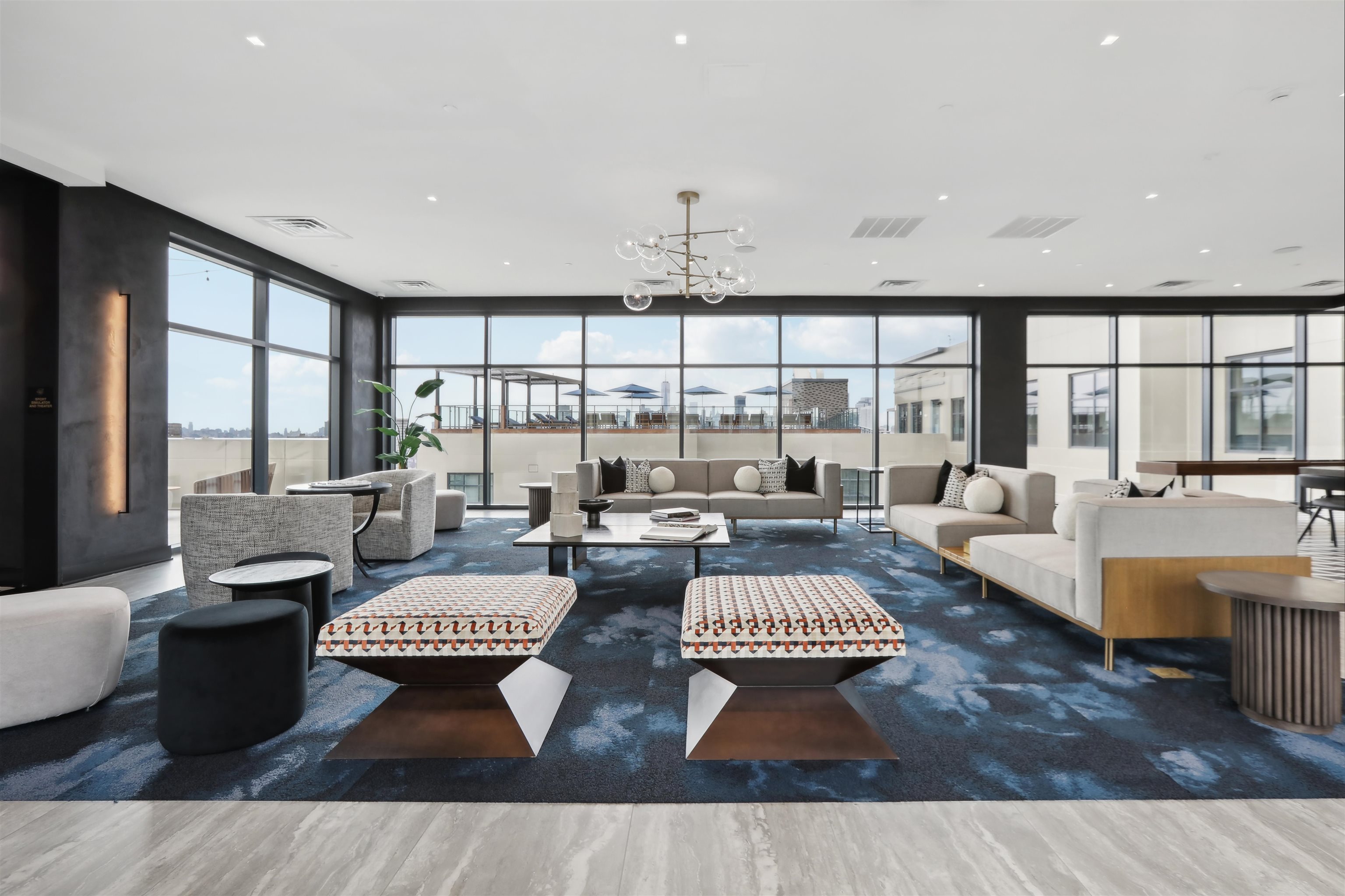 32 Oakland Avenue, Unit 1504 Jersey City, NJ 07306 - Photo 32 of 50 a living room with lots of furniture and large windows