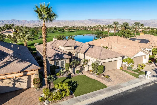 an aerial view of a house with outdoor space patio and lake view