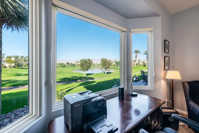 a bathroom with a granite countertop tub sink and mirror