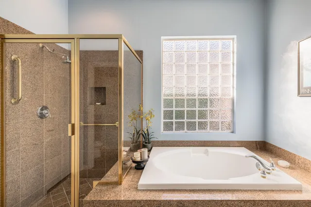 a view of a chairs and table in patio with a lake view