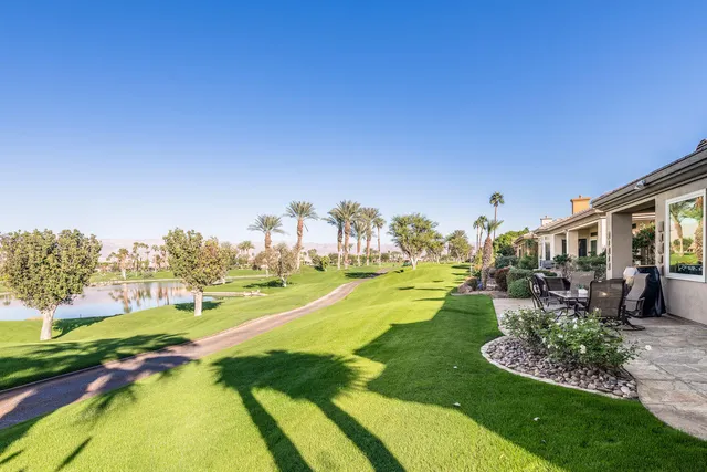 a view of a house with swimming pool and porch with furniture