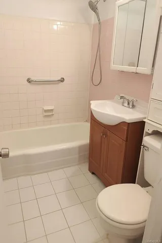a bathroom with a sink a toilet and bathtub