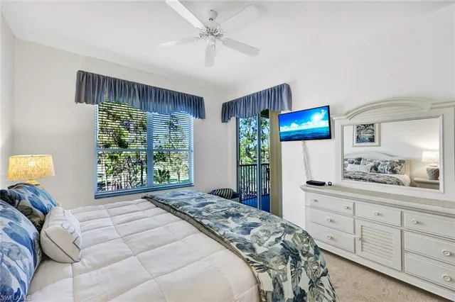 a bedroom with a large bed and a tv on the dresser