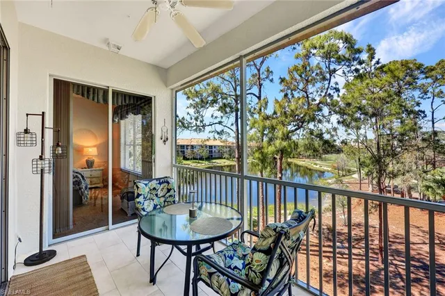 a view of a balcony with furniture and floor to ceiling window