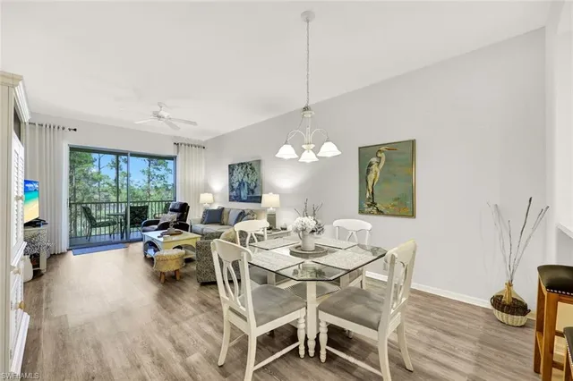 a living room with furniture a window and wooden floor