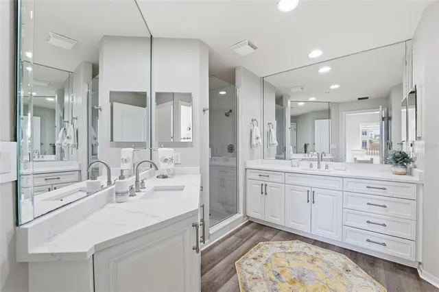 a bathroom with a sink shower and a mirror