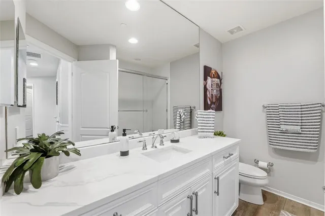 a bathroom with a sink toilet and shower