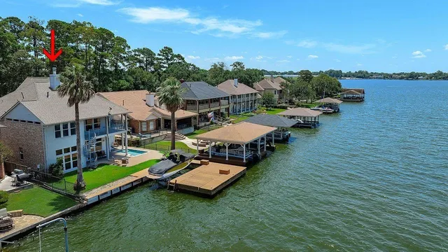 an aerial view of a house with swimming pool garden view and lake view