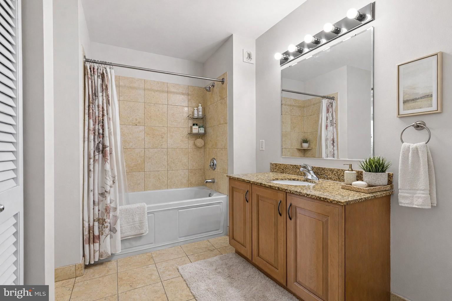 901 North Penn Street, Unit R704 Philadelphia, PA 19123 - Photo 15 of 41 a bathroom with a granite countertop sink a toilet and shower
