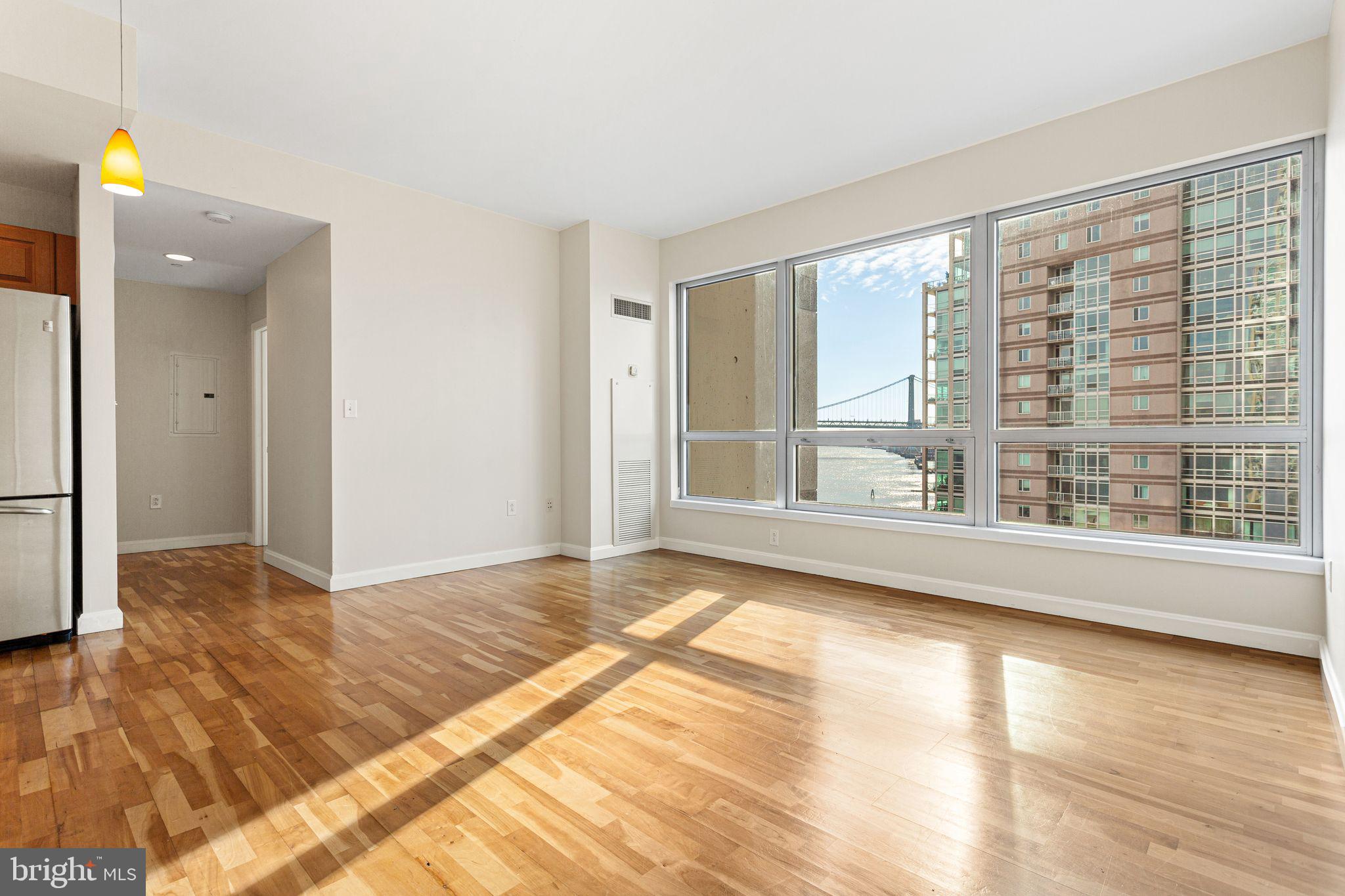 901 North Penn Street, Unit R704 Philadelphia, PA 19123 - Photo 2 of 41 a view of an empty room with wooden floor and a window