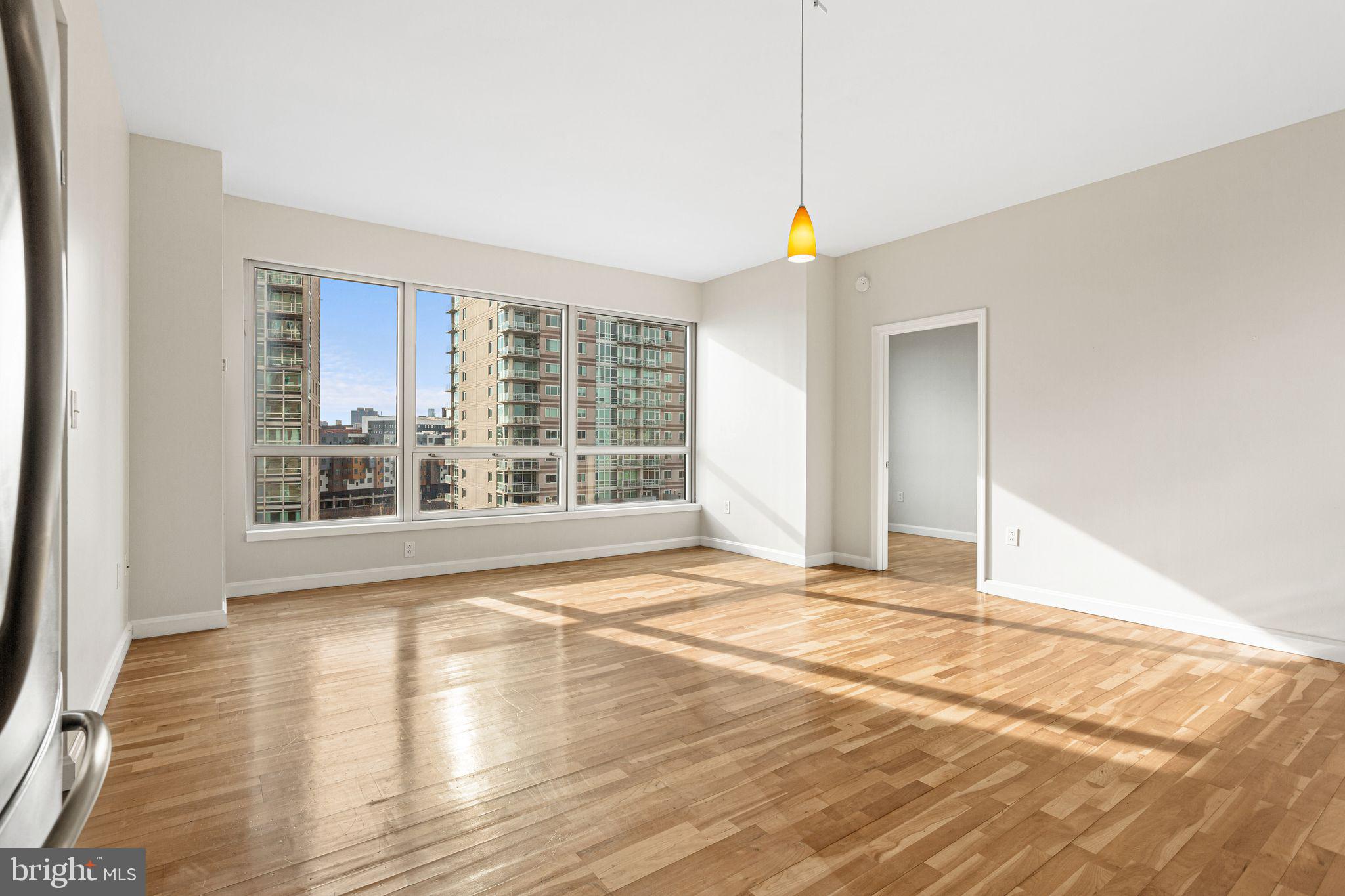 901 North Penn Street, Unit R704 Philadelphia, PA 19123 - Photo 4 of 41 a view of an empty room with wooden floor and a window