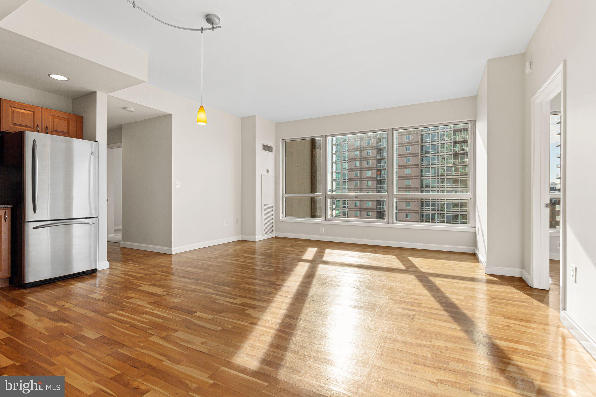 901 North Penn Street, Unit R704 Philadelphia, PA 19123 - Photo 5 of 41 a view of an empty room with a window and a kitchen