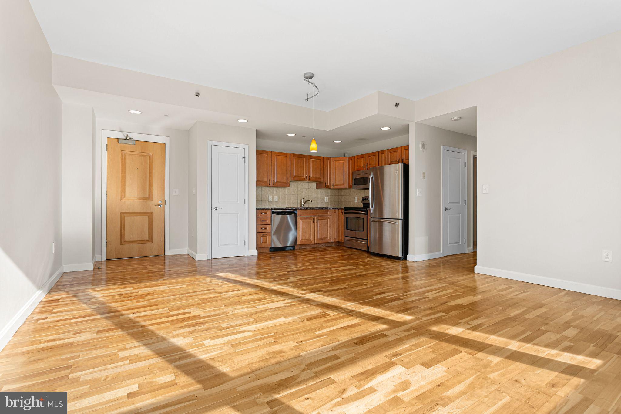901 North Penn Street, Unit R704 Philadelphia, PA 19123 - Photo 6 of 41 a view of a kitchen with a refrigerator and a window