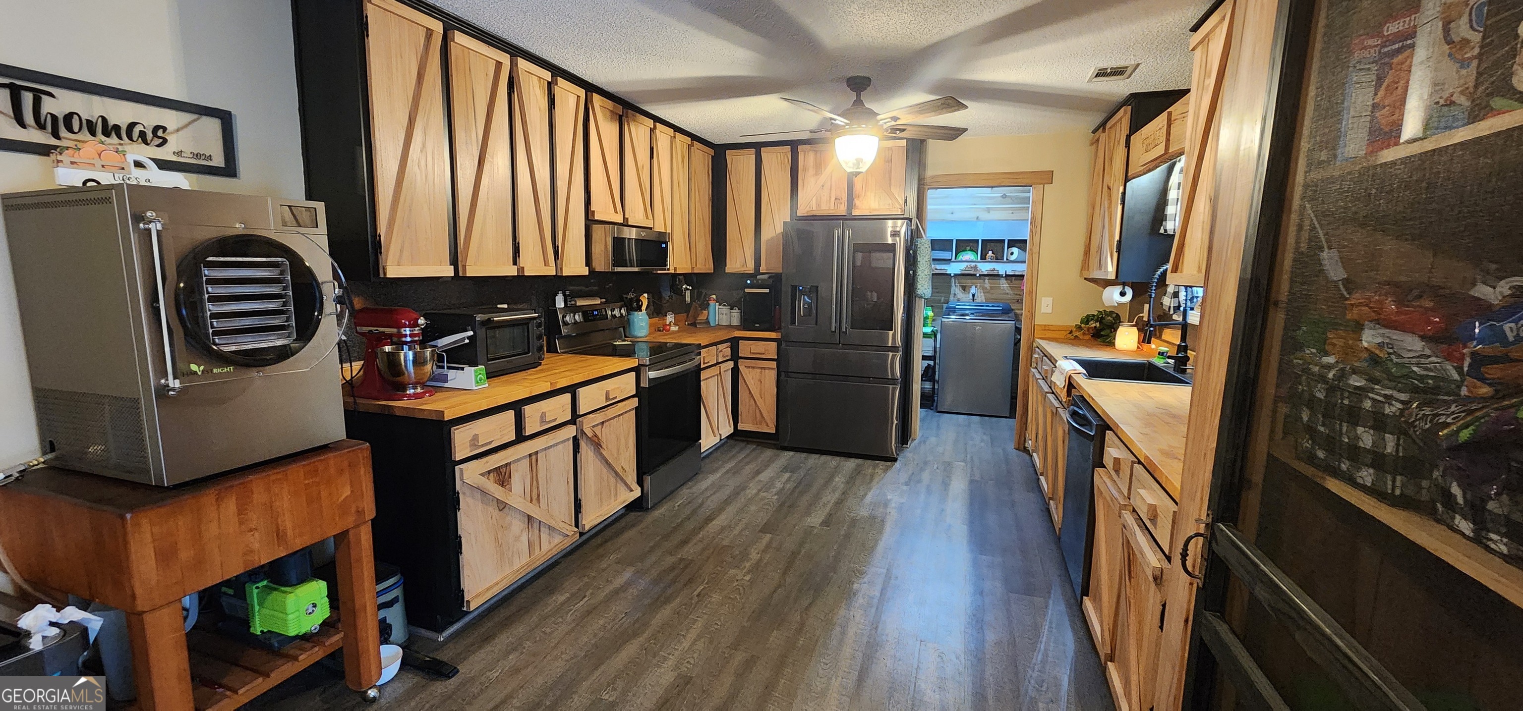 1579 Bates Road Concord, GA 30206 - Photo 22 of 52 a kitchen with stainless steel appliances granite countertop a refrigerator a stove a sink and a microwave