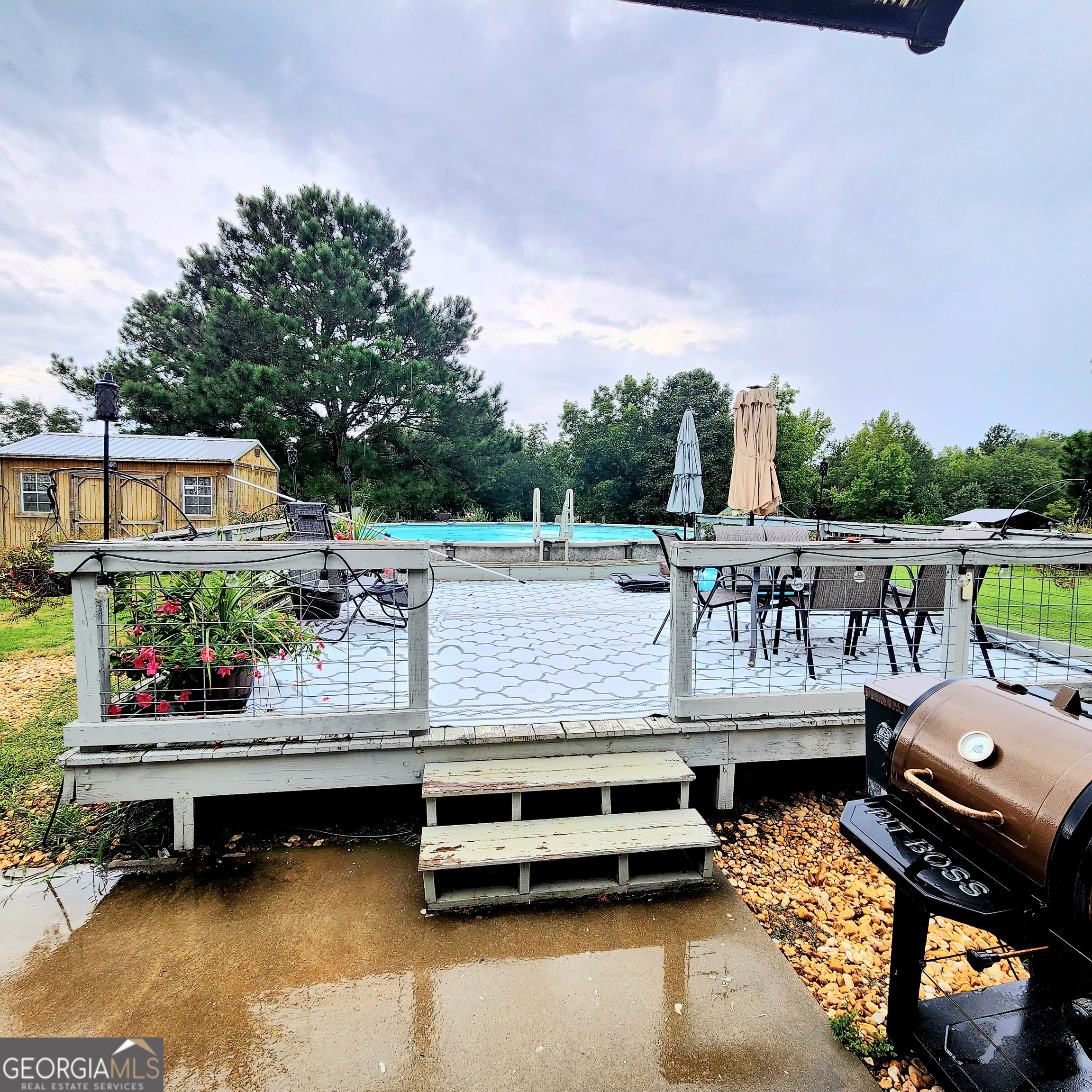 1579 Bates Road Concord, GA 30206 - Photo 35 of 52 a terrace with outdoor seating and trees in the background
