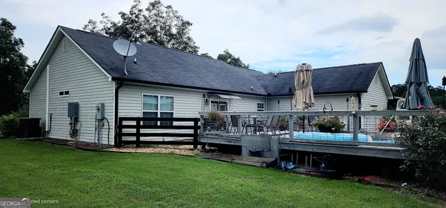 a view of a chairs and table in the back yard