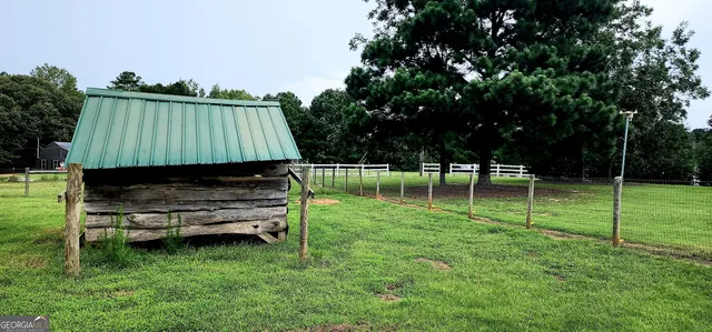 a backyard of a house with a yard and outdoor seating