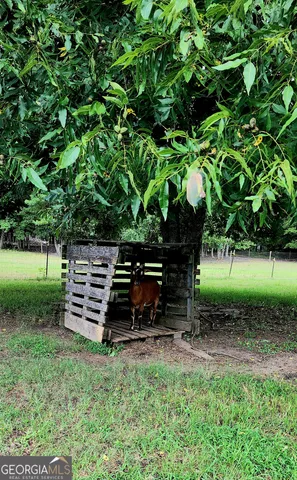 a view of a house with a yard covered in snow