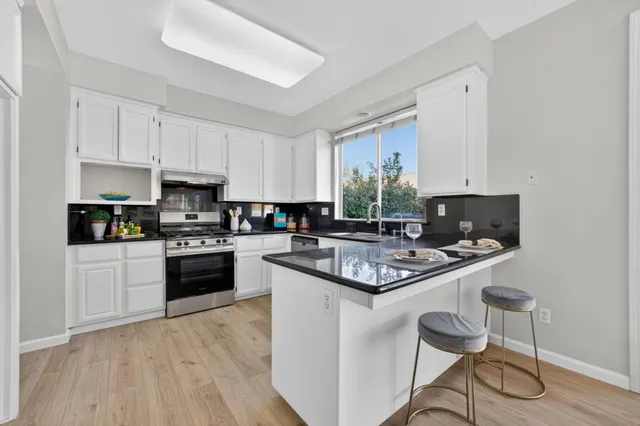 a kitchen with a stove a sink and a refrigerator