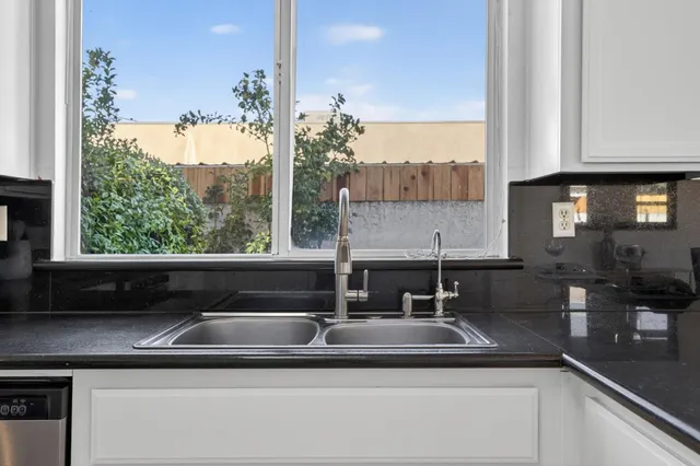 a kitchen with a sink and large window