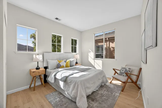 a bed room with a bed and a chair