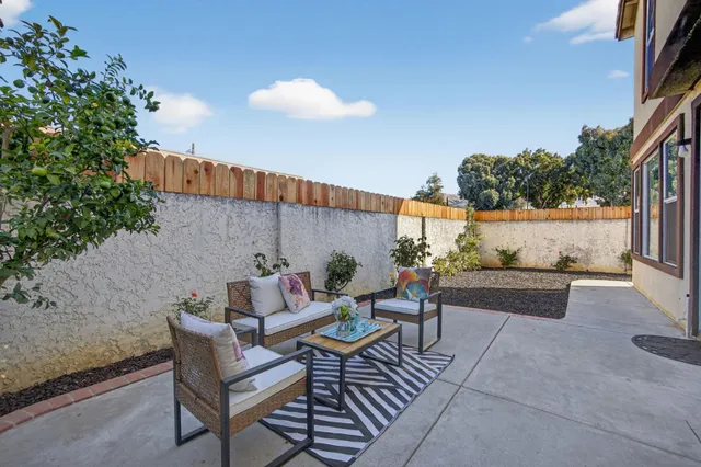 a view of patio with a table and chairs and potted plants