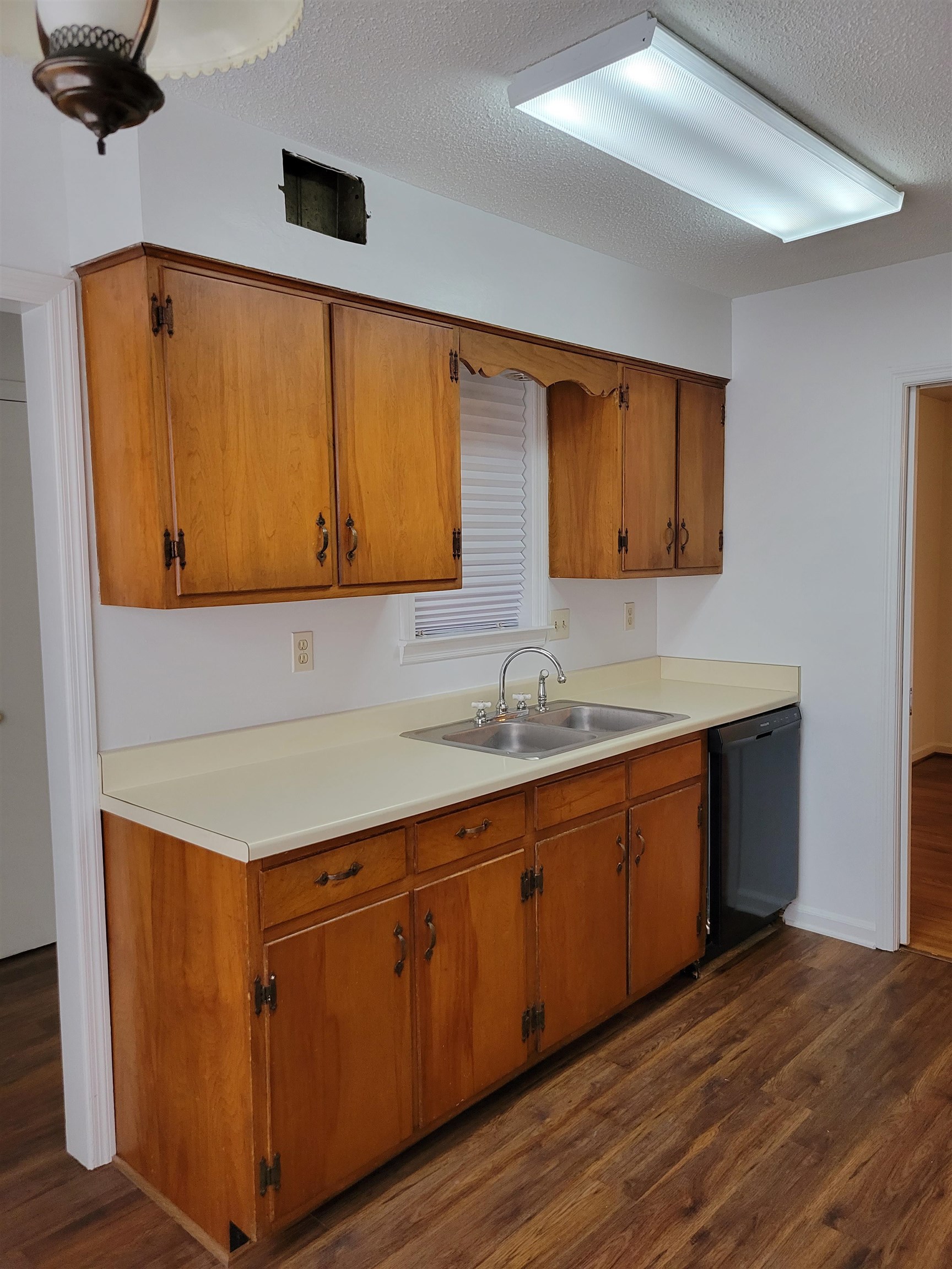 3415 Adrick Road Memphis, TN 38128 - Photo 4 of 22 a kitchen with stainless steel appliances granite countertop wooden cabinets a sink and dishwasher