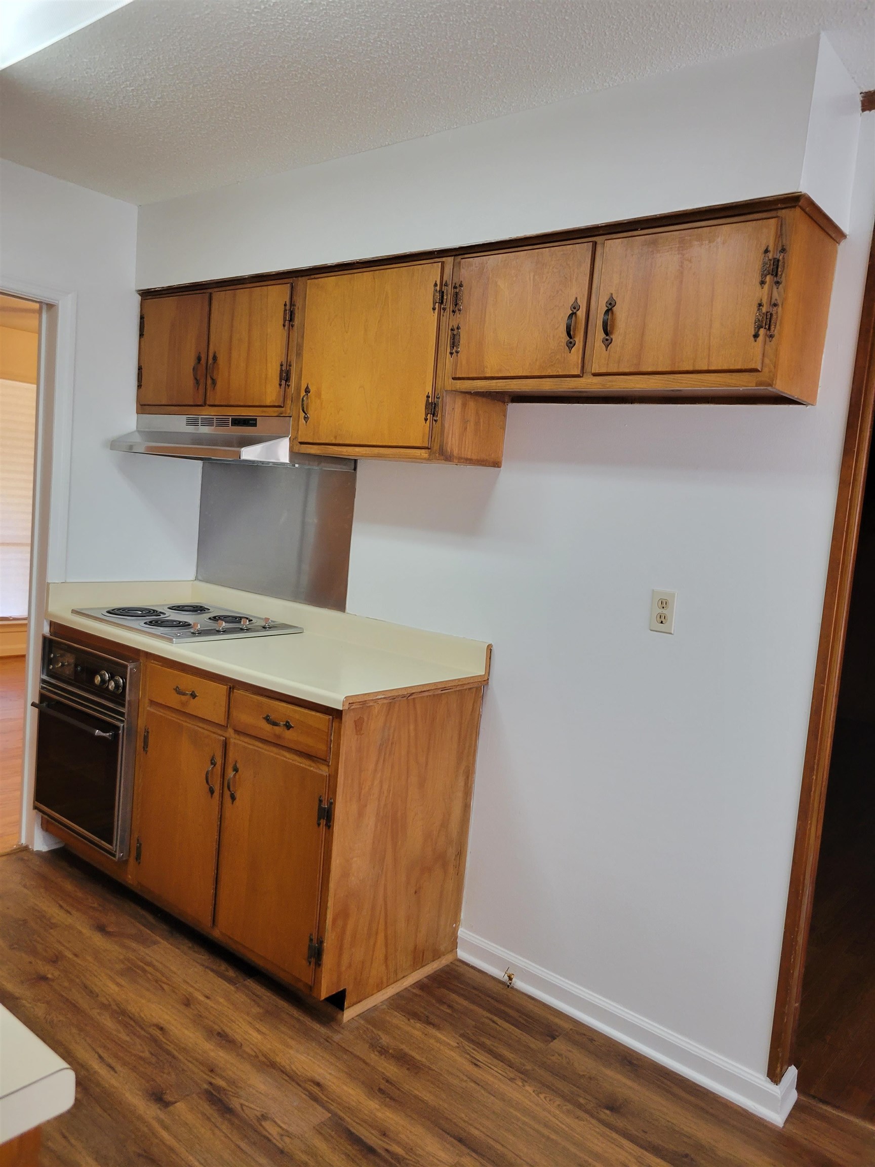3415 Adrick Road Memphis, TN 38128 - Photo 6 of 22 a kitchen with wooden cabinets and a wooden floor