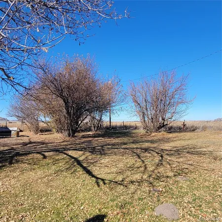 a living room with furniture a flat screen tv and a floor to ceiling window