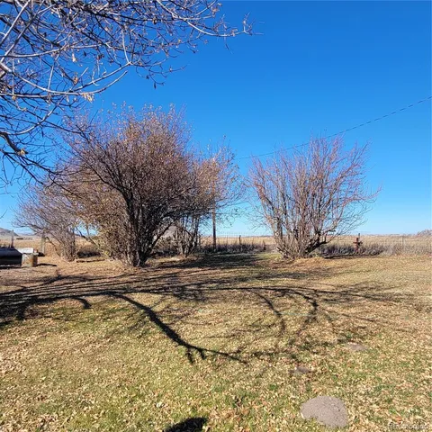 a living room with furniture a flat screen tv and a floor to ceiling window