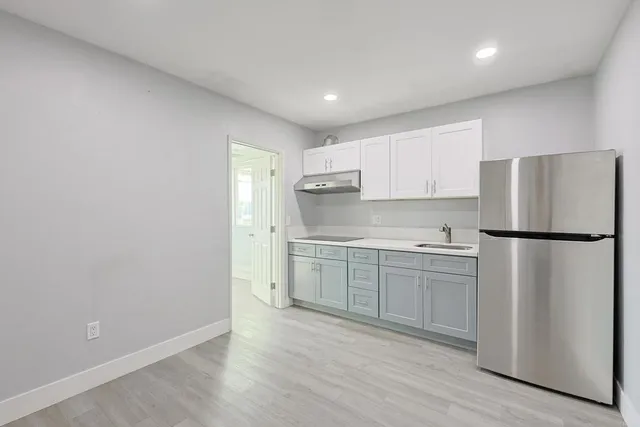 a kitchen with a refrigerator a sink and dishwasher