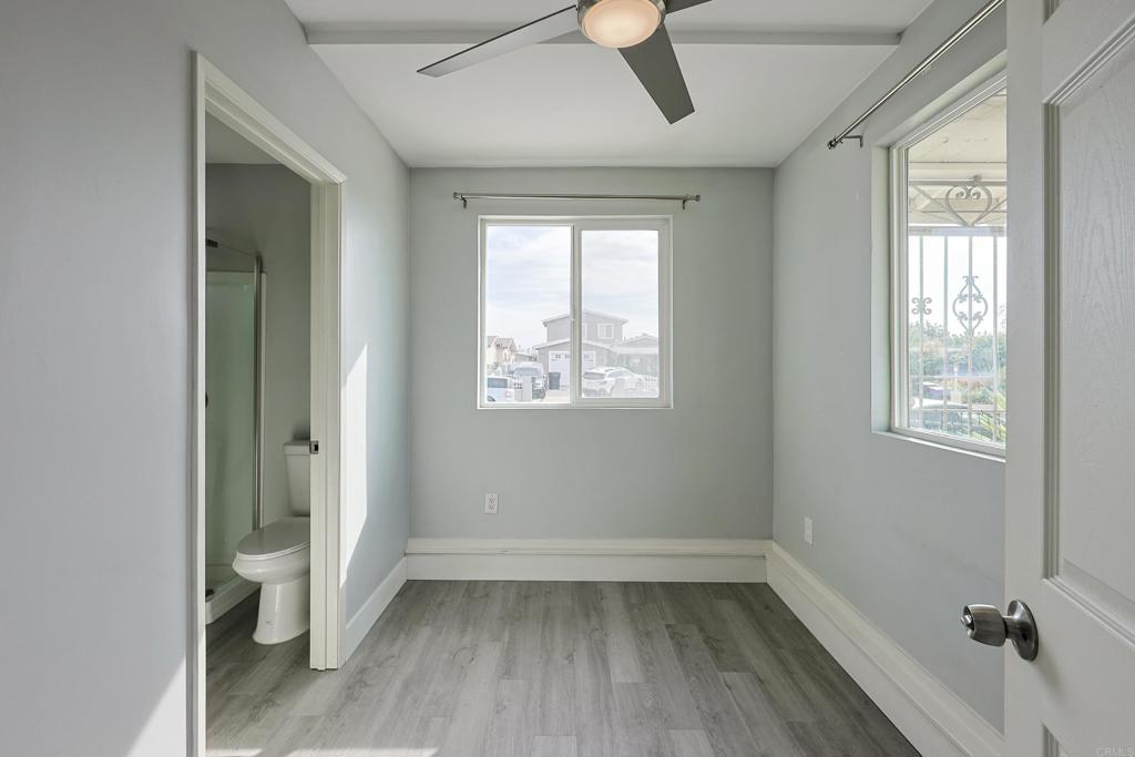 3774 Clavelita Street San Diego, CA 92154 - Photo 11 of 18 a view of an empty room with a window and wooden floor