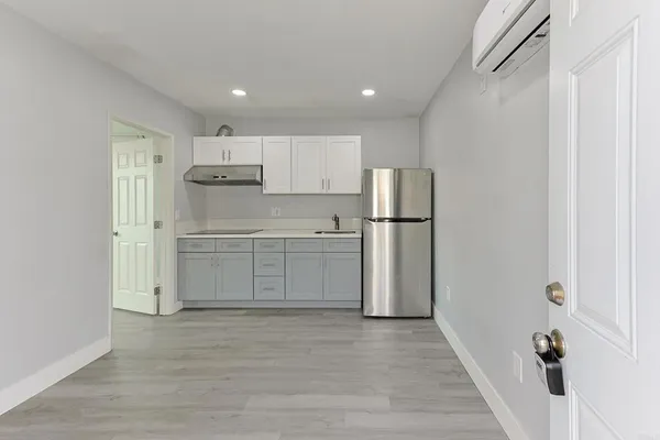 a kitchen with stainless steel appliances refrigerator sink and cabinets