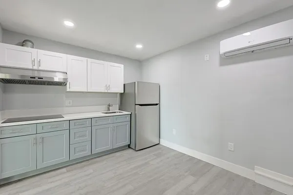 a kitchen with a sink and refrigerator