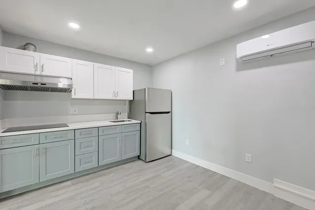 a kitchen with a sink and refrigerator