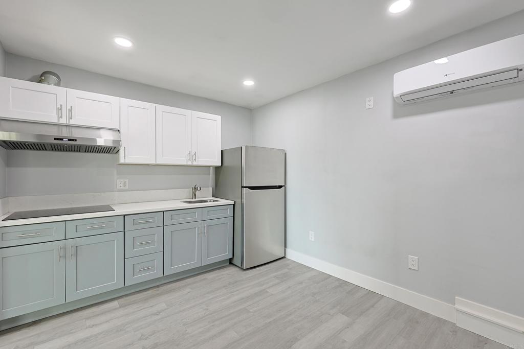3774 Clavelita Street San Diego, CA 92154 - Photo 6 of 18 a kitchen with a sink and refrigerator