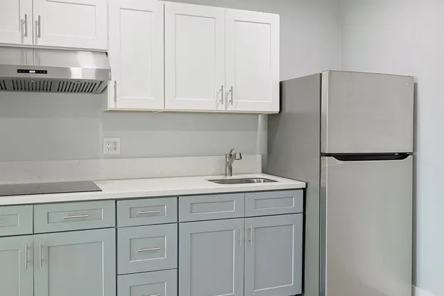 a kitchen with a sink and refrigerator