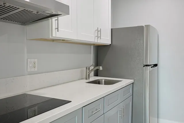 a kitchen with a sink and cabinets