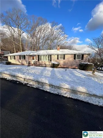 a view of house with outdoor space and sitting area