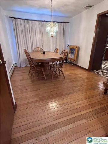 a dining room with furniture and wooden floor