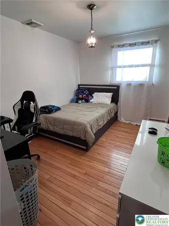 a bedroom with bed and window